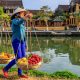 Vietnamese woman selling tropical fruits, old town in Hoi An city, Vietnam. Hoi An is situated on the east coast of Vietnam. Its old town is a UNESCO World Heritage Site because of its historical buildings. 1224548888